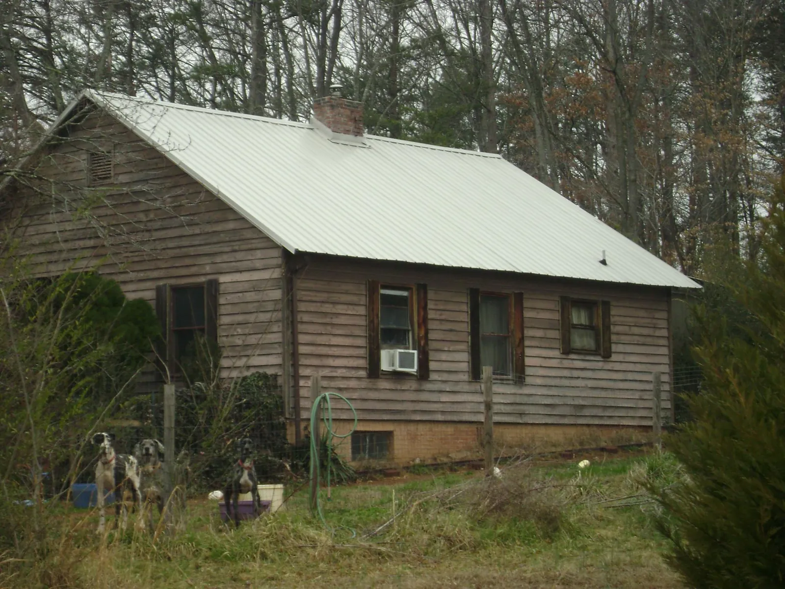 White metal roof on an old wood sided farmhouse, from a Metal Roof Installation job in De Mossville